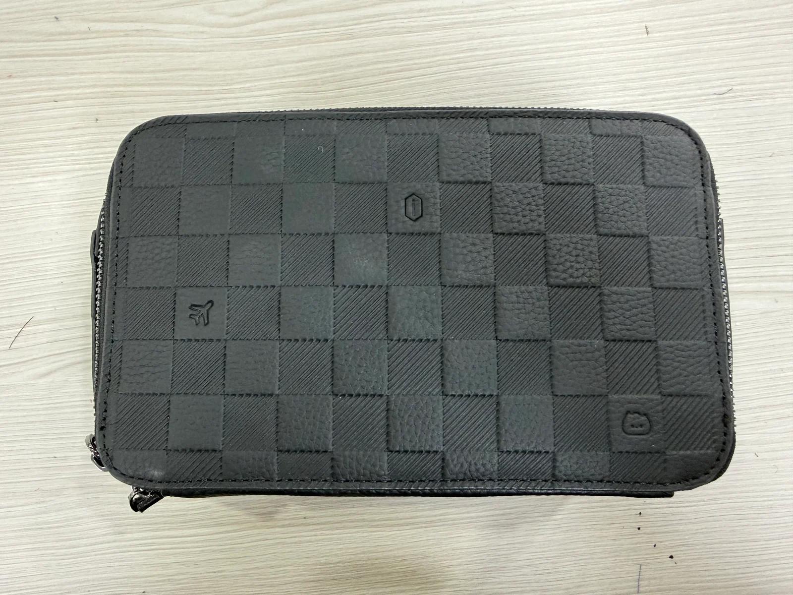 Black genuine leather zip case with a checkered surface and stitched edges